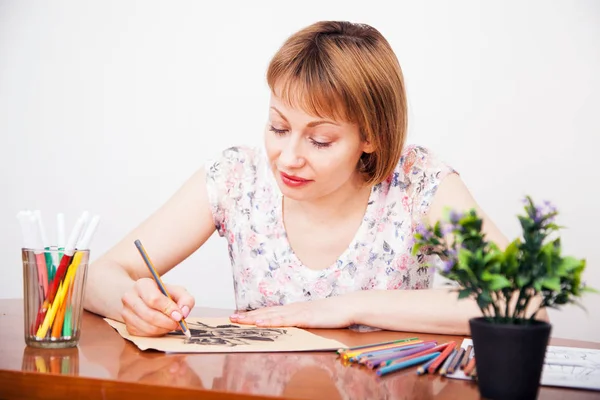 Jonge vrouw tekenen aan de balie — Stockfoto