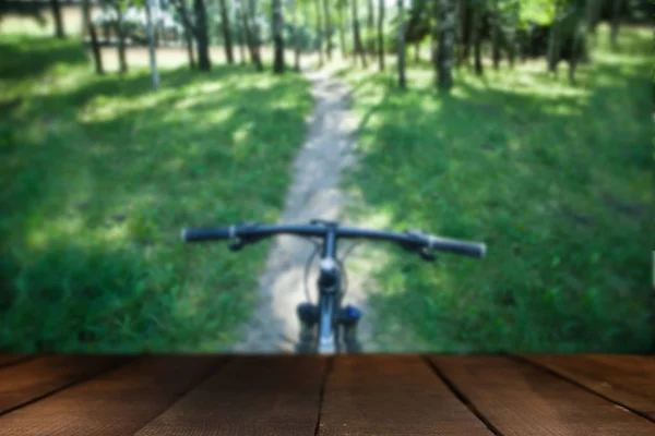 Bike on the forest path with wooden board — Stock Photo, Image