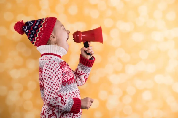 En liten flicka skriker nåt i megafonen. — Stockfoto