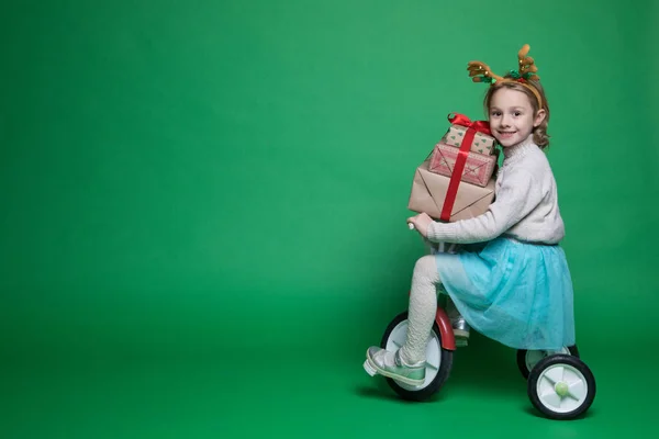 Happy little girl with presents at Christmas time — Stock Photo, Image