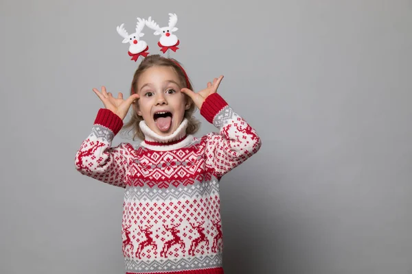 Funny kid with Christmas band. Cheerful smiling little girl . — Stock Photo, Image