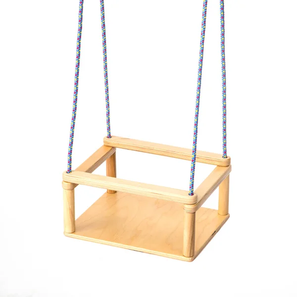 Childrens swing fixed on the ropes on the white . — Stockfoto
