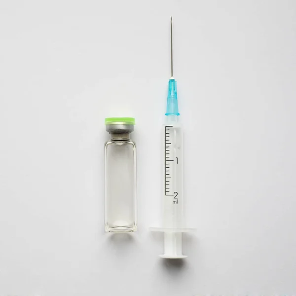 Medical ampoules and syringe on the science background — Stock Photo, Image