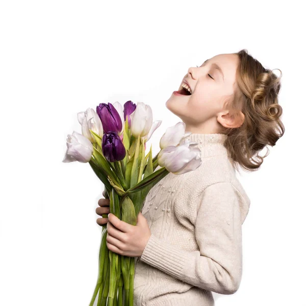 Klein meisje met een boeket tulpen. — Stockfoto