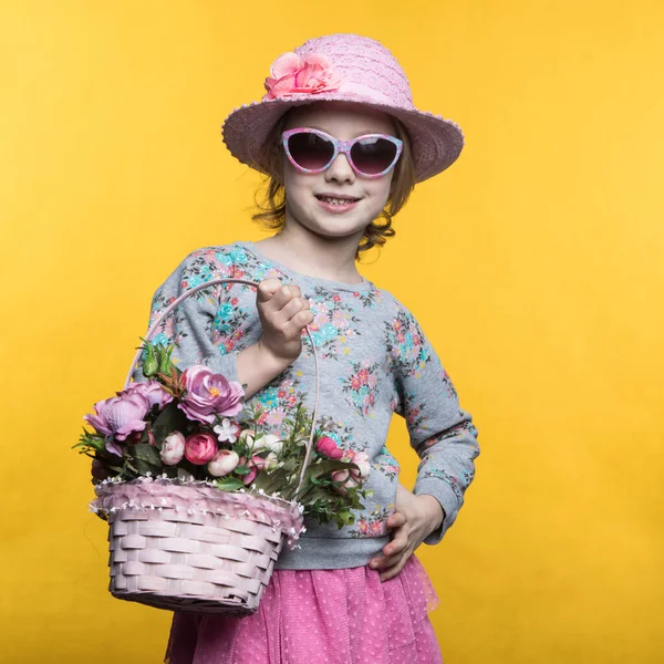 Little smile girl with flowers in basket. — Stockfoto