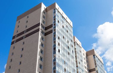 Mavi gökyüzü arka plan karşı yeni uzun boylu apartman