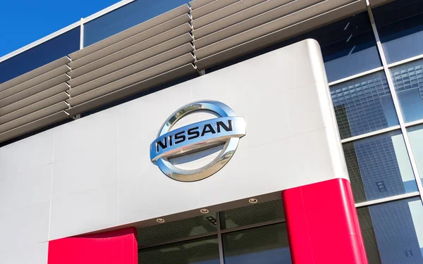 Official dealership sign of Nissan. Nissan is a Japanese multina — Stock Photo, Image