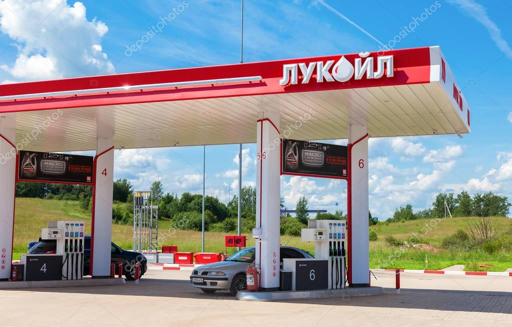 BOROVICHI, RUSSIA - JUNE 26, 2016: Lukoil gas station with fueling cars. Lukoil is the largest privately owned oil and gas company in the world by proved oil reserves
