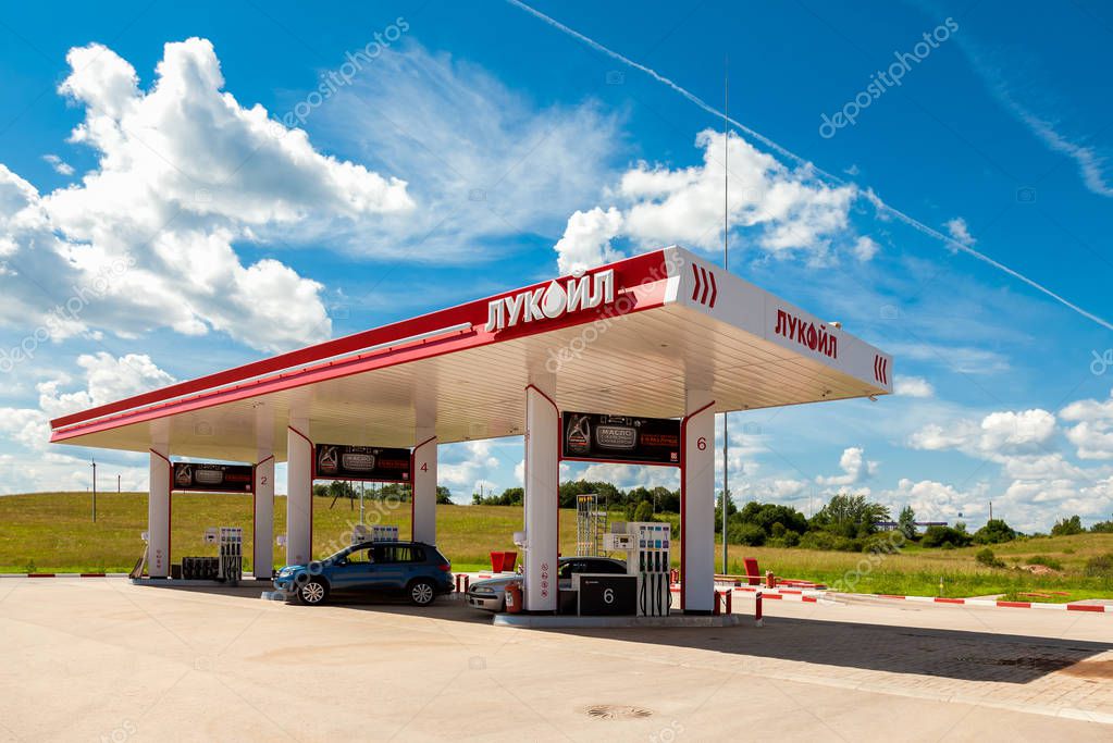 BOROVICHI, RUSSIA - JUNE 26, 2016: Lukoil gas station with fueling cars. Lukoil is the largest privately owned oil and gas company in the world by proved oil reserves