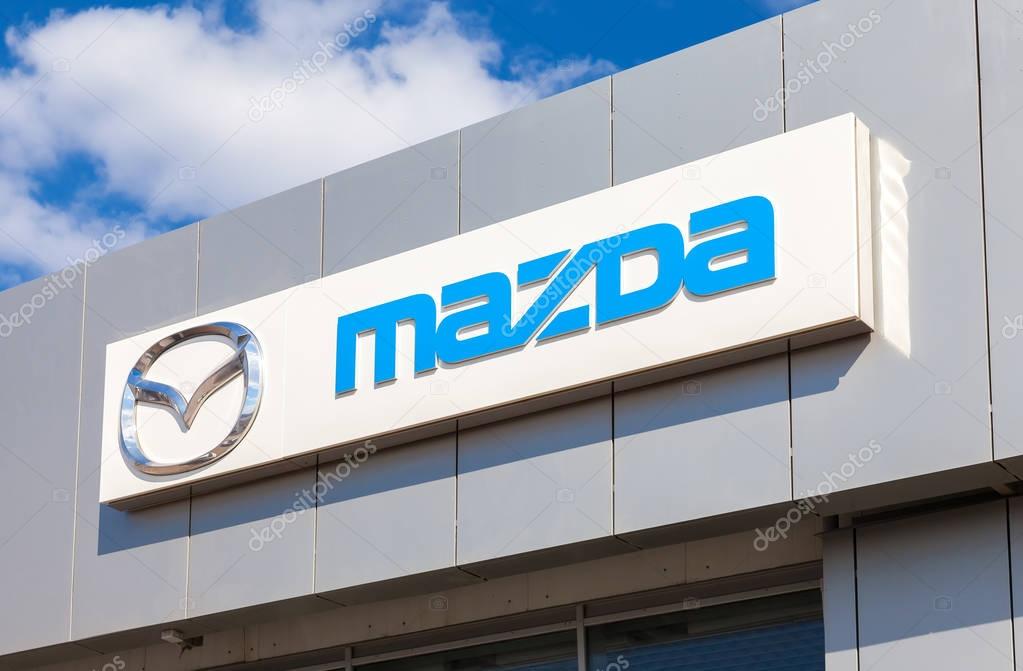SAMARA, RUSSIA - MAY 11, 2016: Mazda logo on the facade of official dealer office. Mazda Motor Corporation is a Japanese car brand, automotive manufacturer