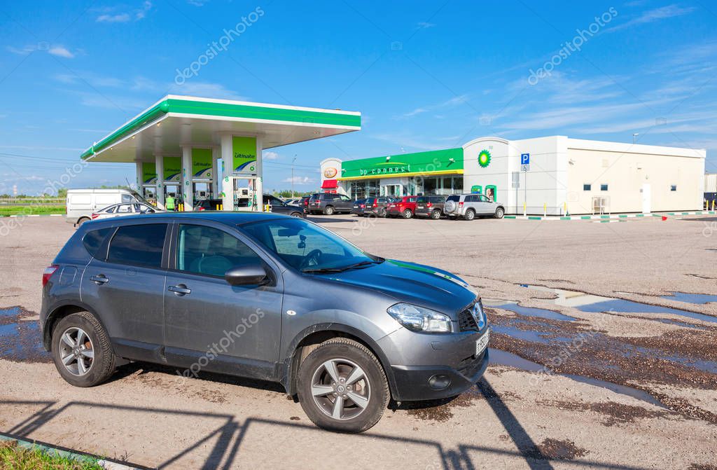 NOVGOROD REGION, RUSSIA - JULY 31, 2016: Car Nissan Qashqai on the background of BP petrol station. British Petroleum is a British multinational oil and gas company