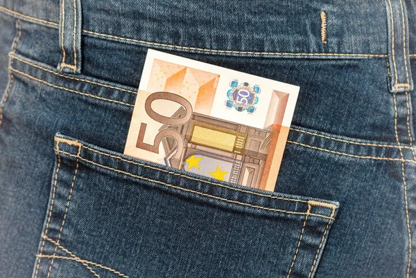 Banknote 50 euro sticking out of the blue jeans pocket. Money fo — Stock Photo, Image