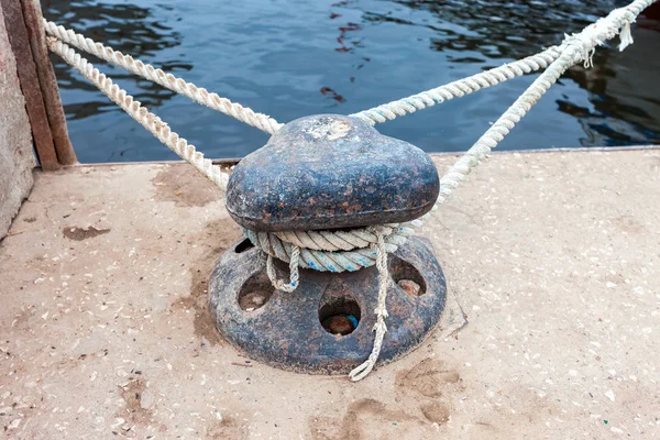 Oude metalen Bolder van de ligplaats met een vaste touw op de pier — Stockfoto