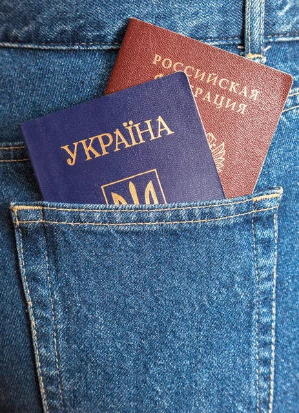 Russian and Ukrainian passports in the back jeans pocket