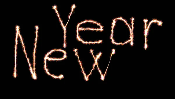 Glowing neon Happy new year lettering written with fire flame or