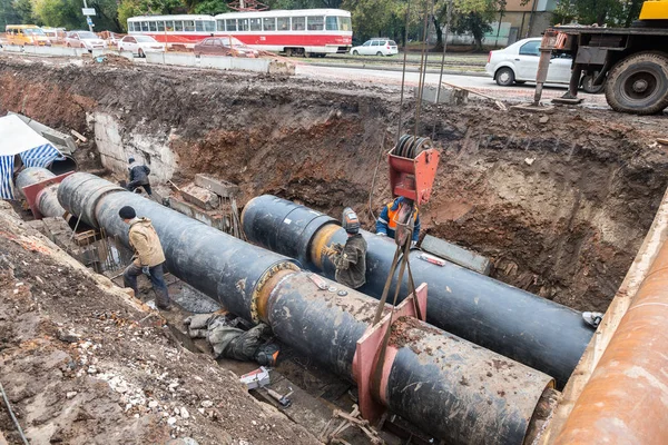 Travaux de réparation de conduits de chauffage. Les ouvriers, soudeurs fabriqués par électr — Photo