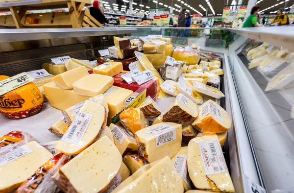 Tasty freshly cheese ready to sale in the showcase at the superm — Stock Photo, Image