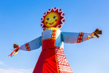 Traditional big doll for the burning on the blue sky background clipart