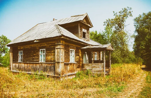 Retro photo with old wooden broken house in russian abandoned vi — Stock Photo, Image