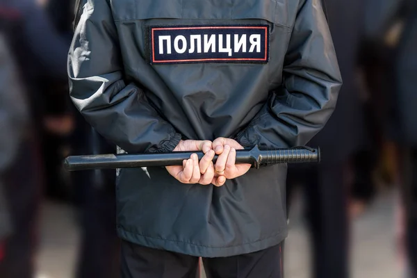 Russian policeman with police truncheon. Text in russian: Police — Stock Photo, Image