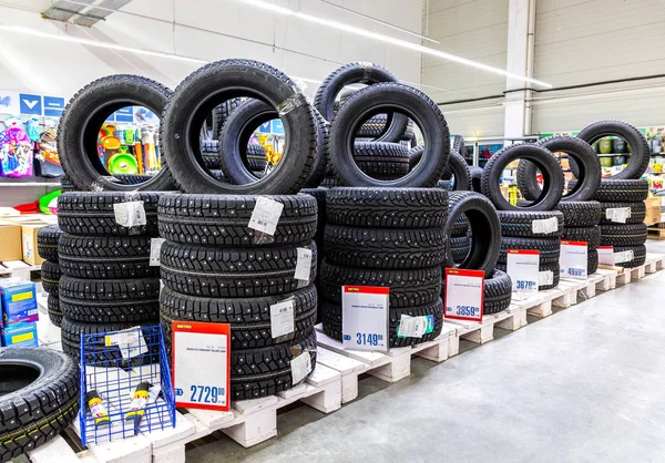 Stock image Winter vehicle tires stacked up for sale 