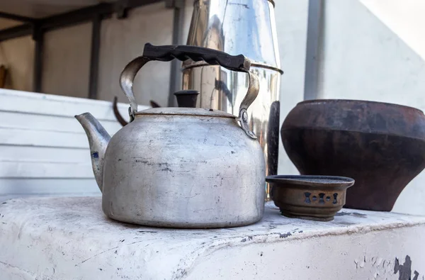 Metal kettle and other utensils on the stove — Stock Photo, Image