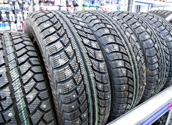 Winter vehicle tires stacked up for sale in the hypermarket — Stock Photo, Image