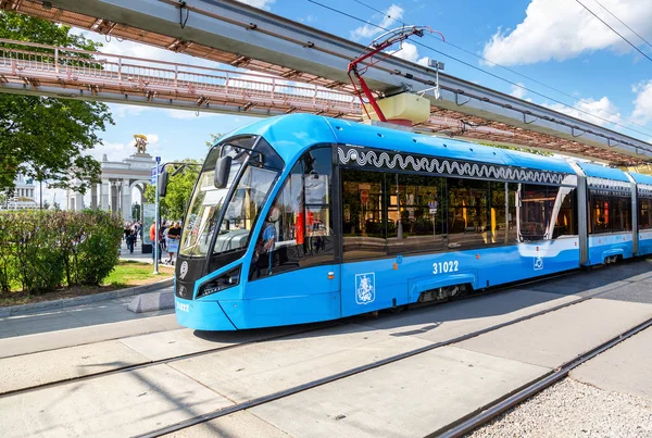 Tram travels along a city street along the monorail line next th — 스톡 사진