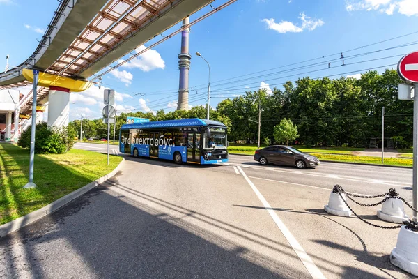 Electric bus travels along a city street along the monorail line — 스톡 사진