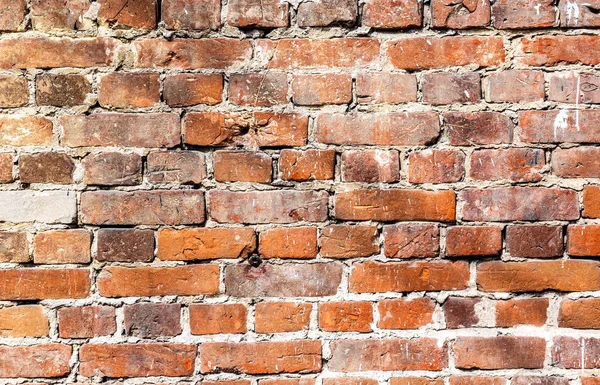 Weathered stained brick wall as background — Stockfoto