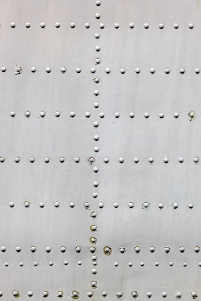 Metal surface with rivets as background — Stock Photo, Image