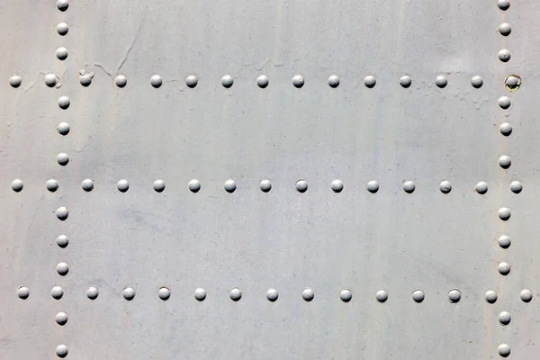 Metal surface with rivets as background — Stock Photo, Image