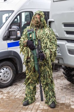 Samara, Russia - February 23, 2020: Special Forces soldier in camouflage robe with sniper rifle in hands