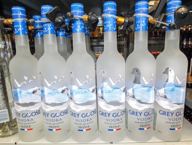 Samara, Russia - February 22, 2020: Grey Goose vodka ready for sale on the shelf in superstore. Various bottled alcoholic beverages and spirit drinks