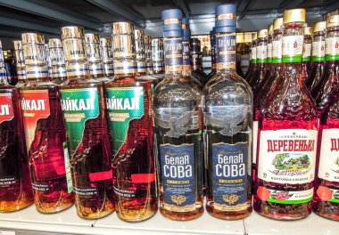 Samara, Russia - February 22, 2020: Different russian's vodka ready for sale on the shelf in superstore. Various bottled alcoholic beverages and spirit drinks