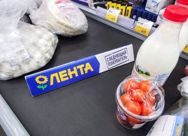 Samara, Russia - February 22, 2020: Goods separator on the conveyor belt in hypermarket Lenta. Text in Russian: Lenta, next purchaser