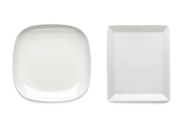 Zwei weiße Teller quadratischer Form auf weißem Hintergrund. Ansicht f lizenzfreie Stockfotos