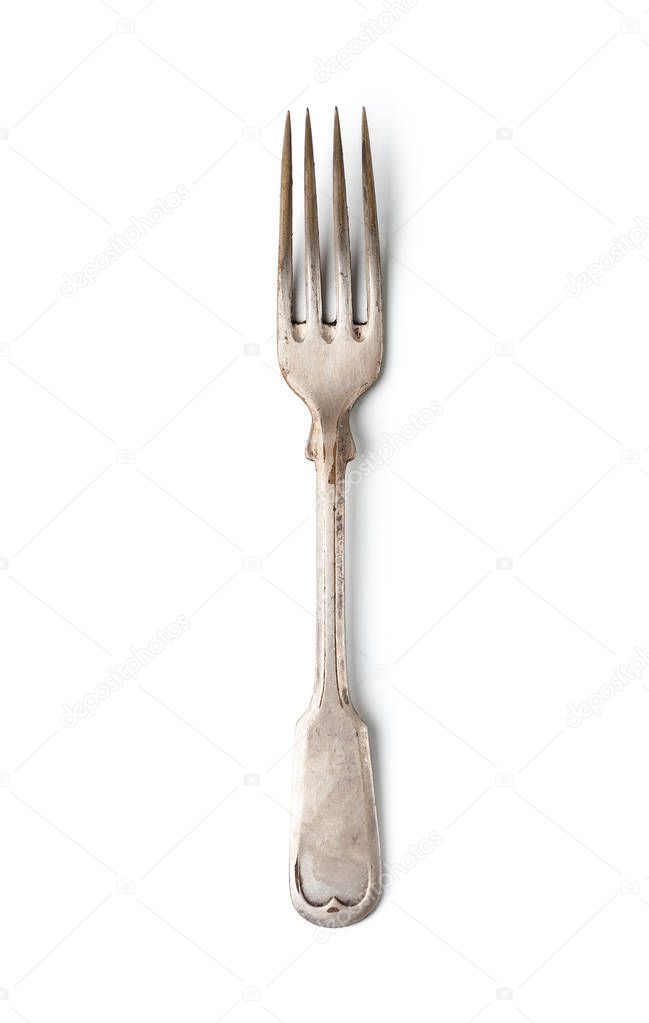 An old worn fork in a classic style. Isolated on white backgroun