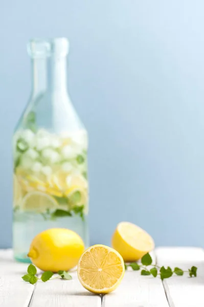 Olgun limon ve nane yaprakları bir şişe o arka planı
