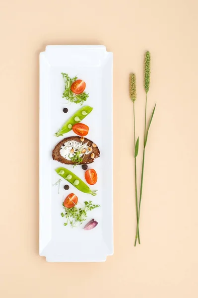 Salata genç yeşil bezelye, domates ve kruton krem üzerinde bir