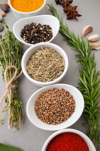 Various spices and spicy herbs close-up on a light gray table — Stock Photo, Image