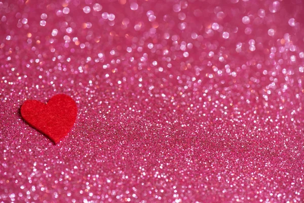 Srdce přes růžové abstraktní pozadí s bokeh — Stock fotografie