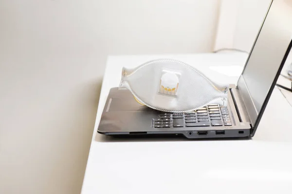 Black notebook with protecting mask on the table. Coronavirus concept. Work from home concept — Stock Photo, Image