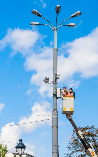 Workers renovating urban lighting. Moscow