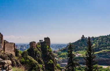 Tourists looking down who climbed ruins at Narikala- an ancient 