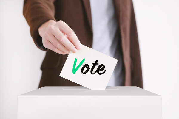 Voting. Putting a ballot.