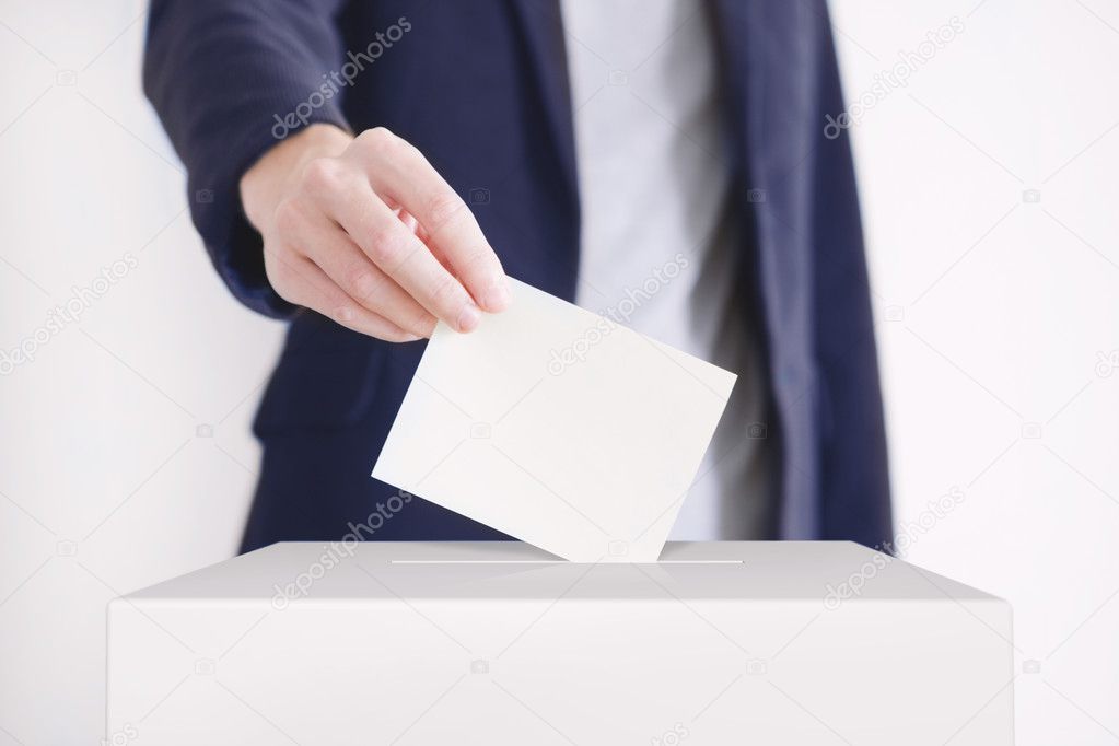 Voting. Man putting a ballot.