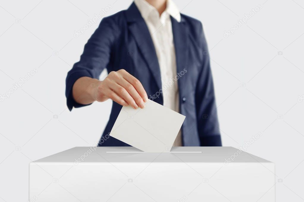 Woman putting a ballot.