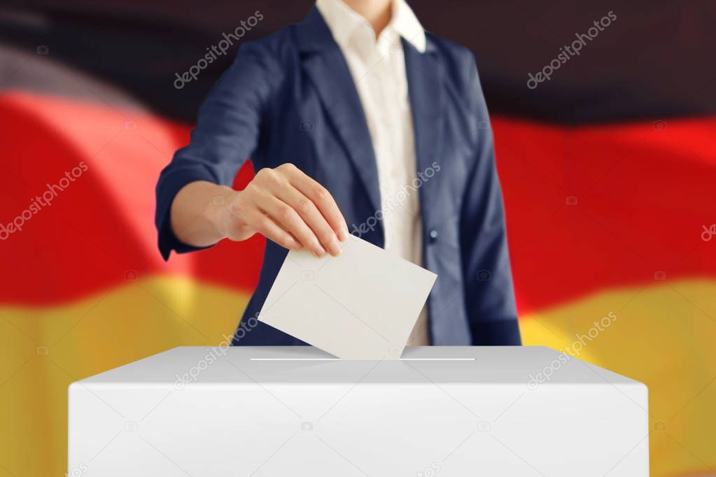 Voting. Woman putting a ballot.