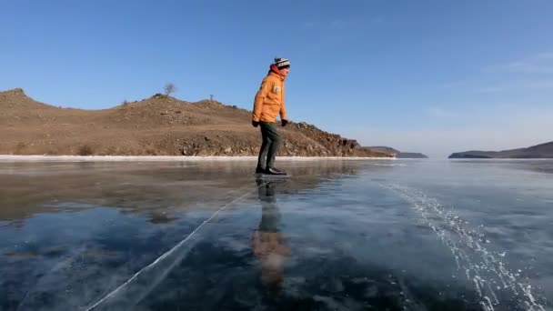 ロシアの美しいバイカル湖での若い男のアイススケート スローモーション — ストック動画